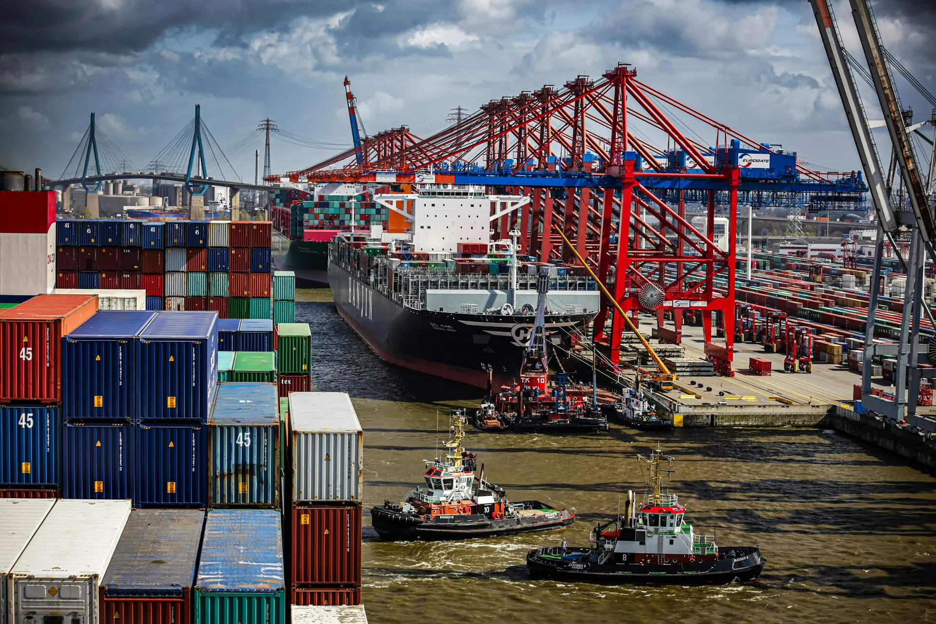 Port terminal cranes working a berthed container vessel